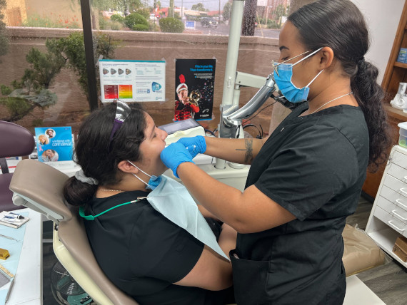 female dental assistants practicing in dentists office