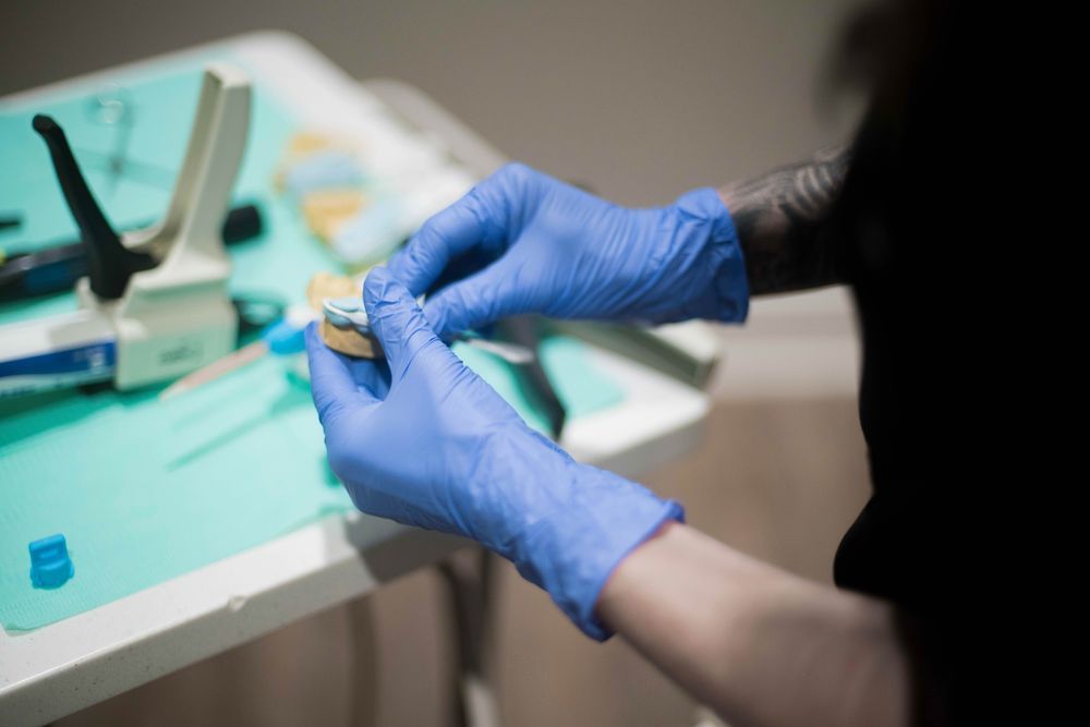 Dental student cleaning dental instruments
